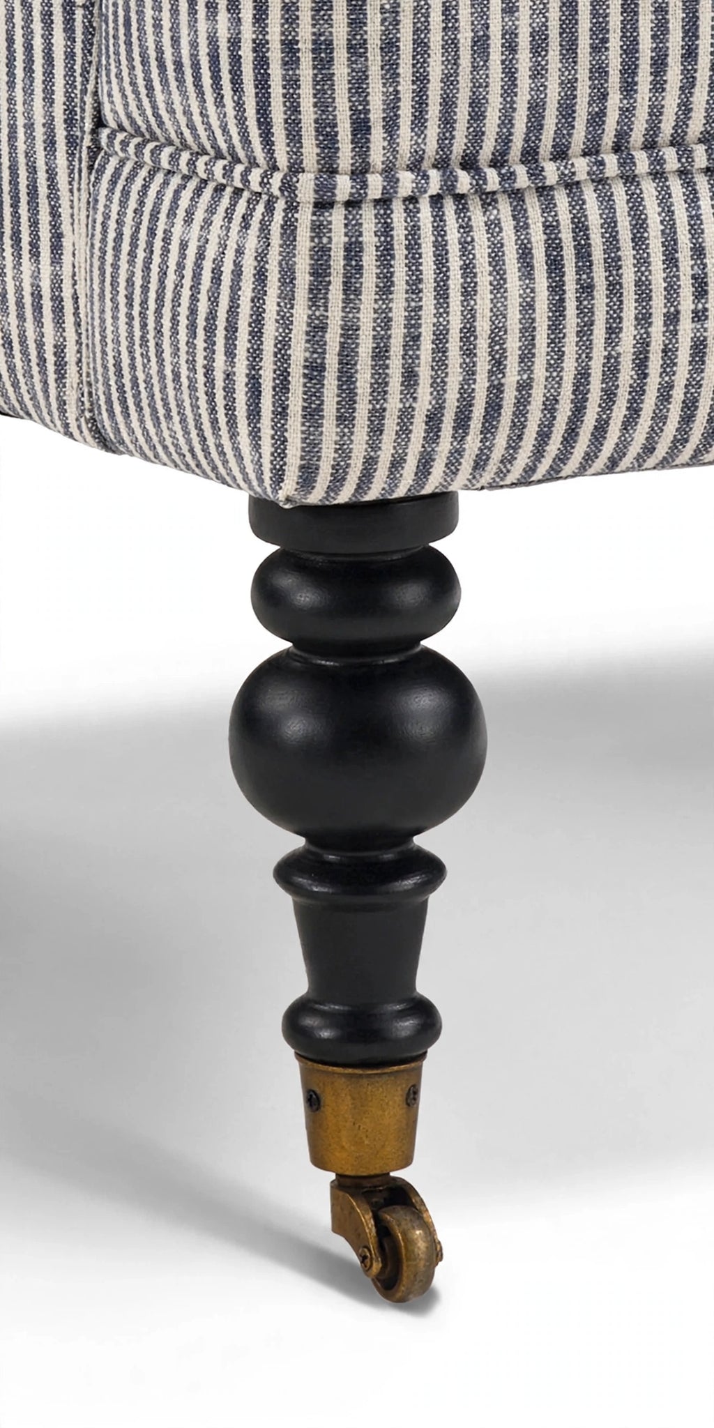 Turned wood leg with brass caster detail