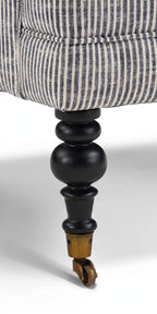 Turned wood leg with brass caster detail