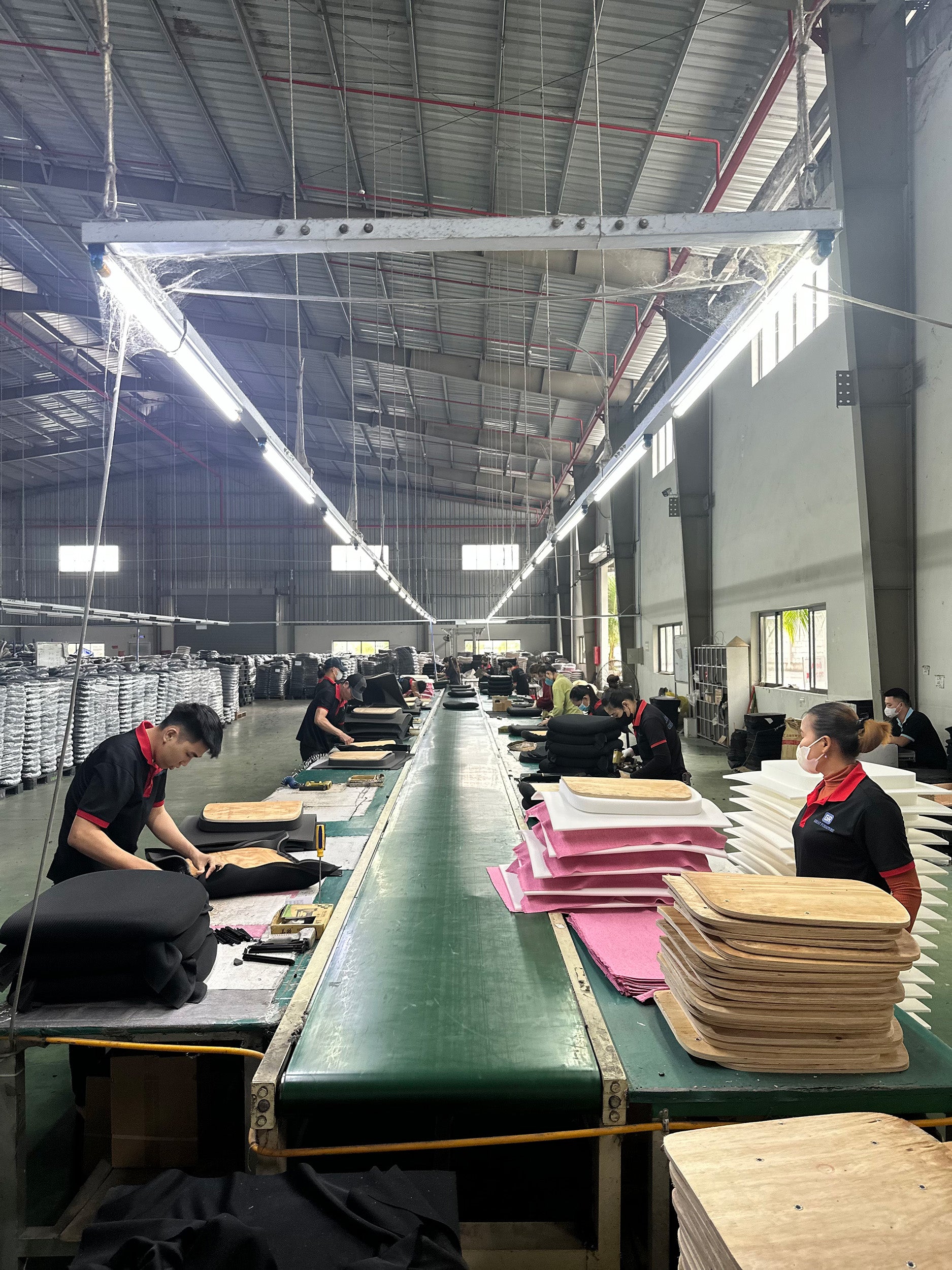 Great Furniture production line, staff hand-assembling chairs